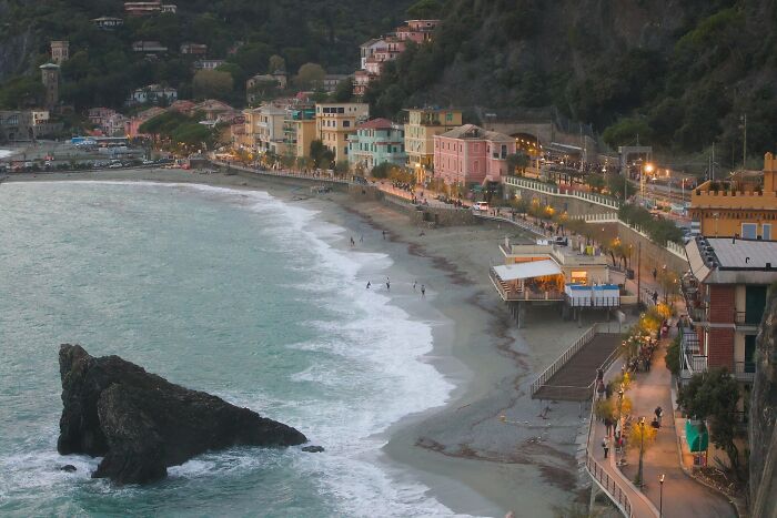 Stunning beach view with beachfront buildings, inviting waves, and a scenic coastline.