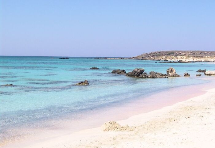 Stunning beach with turquoise water and clear sky, perfect for booking a plane ticket.