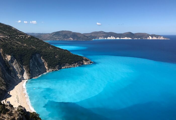 Stunning beach with turquoise water and rugged cliffs, perfect for travel inspiration.