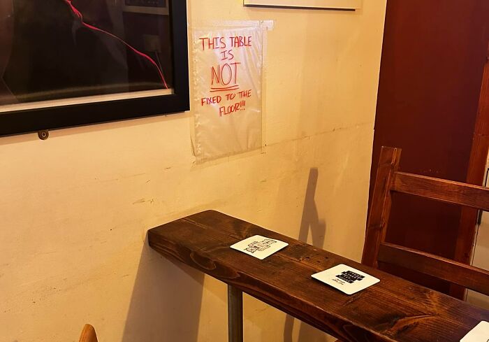 Table with warning sign not affixed to floor, showcasing aftermath of a big mistake.