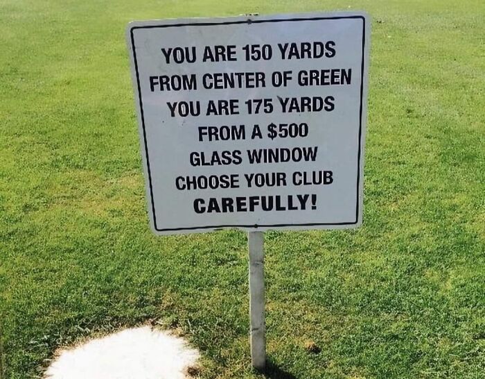 Golf course warning sign humorously advises choosing club to avoid breaking $500 window.