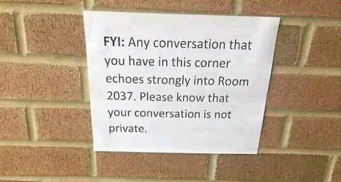 Sign on brick wall warning conversations echo into Room 2037, indicating lack of privacy.