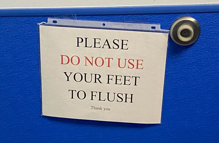 Sign on a blue door stating, "Please do not use your feet to flush," highlighting a common mistake.