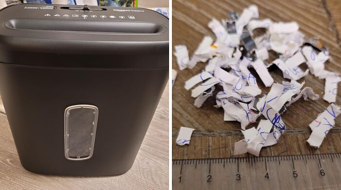 Shredder used for spring cleaning, showing shredded paper pieces on a wooden floor for organization.