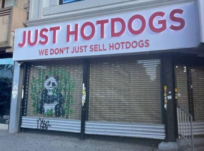 Sign reads "Just Hotdogs," with graffiti of a panda on the storefront.