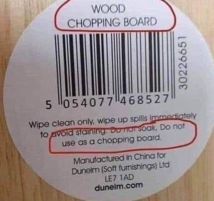 Label on wood board: "Do not use as chopping board." Warning sign of design mistake.