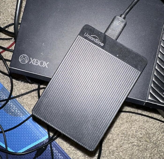 External hard drive and Xbox among cables, representing spring cleaning tips.