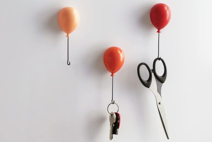 Balloon-shaped hooks holding keys and scissors, a unique spring find for home organization.