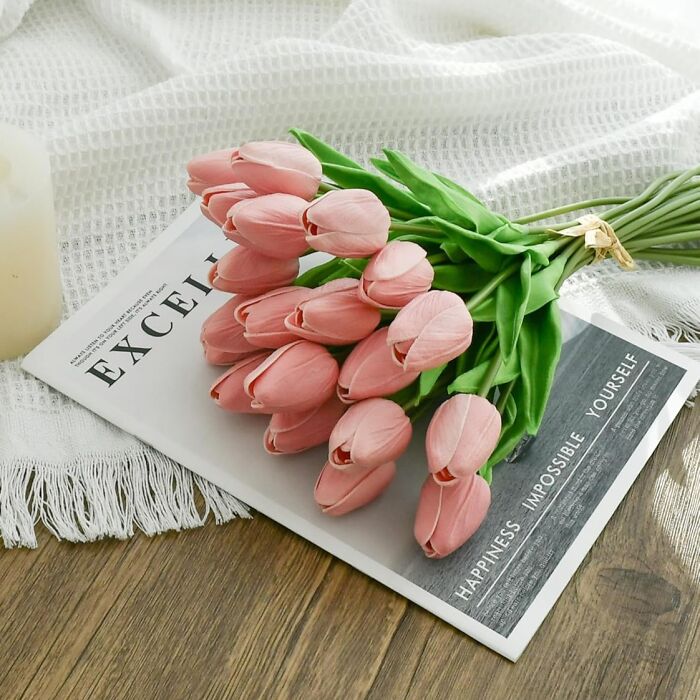 Pink tulips on a magazine, symbolizing spring finds.