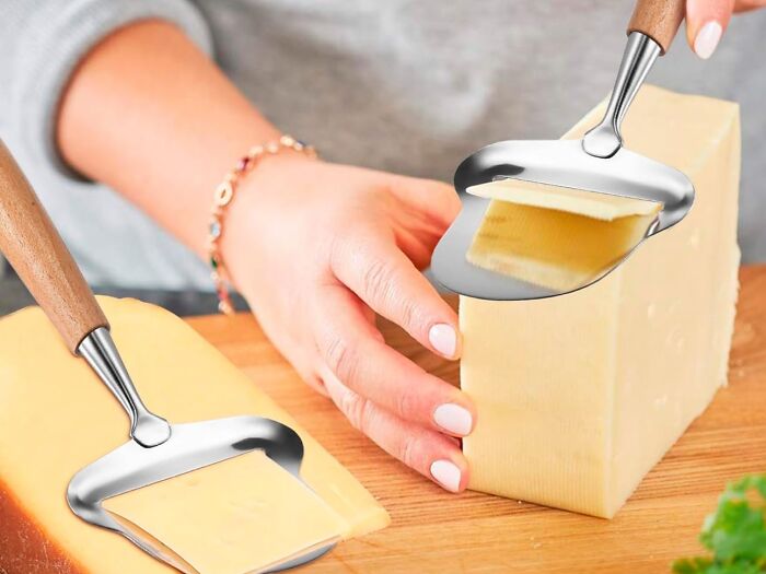 Person using cheese slicer tool on block of cheese.