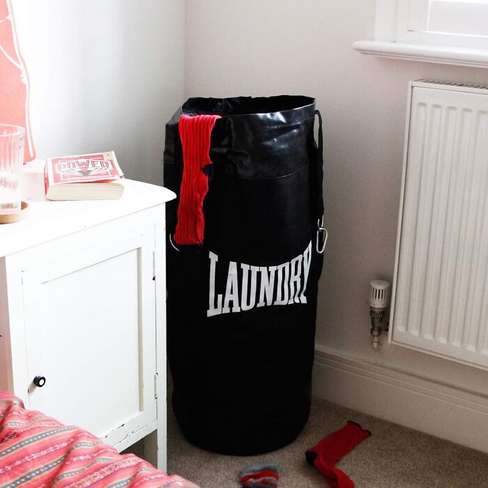 Laundry bag designed like a punching bag in a bedroom corner, emphasizing creative tools for unique home tasks.