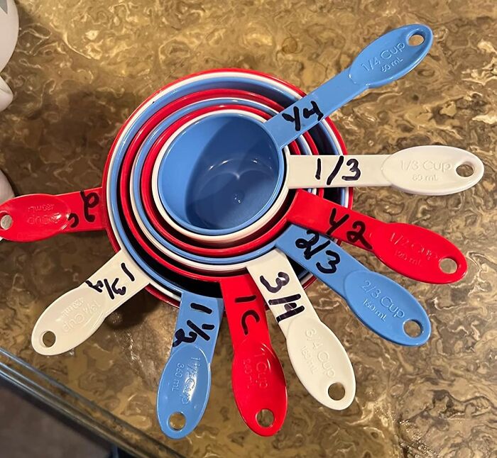 Colorful measuring cups for jobs you didn’t know you needed, stacked on a countertop.