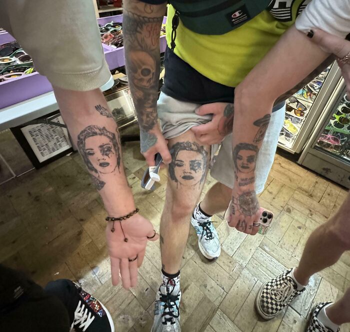 Matching tattoos showcased on arms and a leg, highlighting unique artwork.