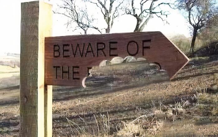 Beware sign with text partially erased, symbolizing aftermath of a big mistake in a rural setting.