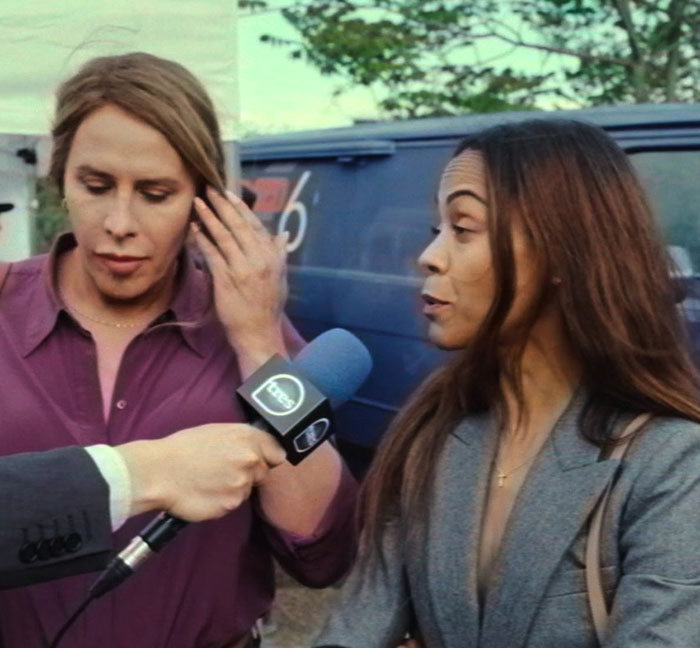 One person speaking to a reporter with a microphone, discussing Oscars apology controversy.