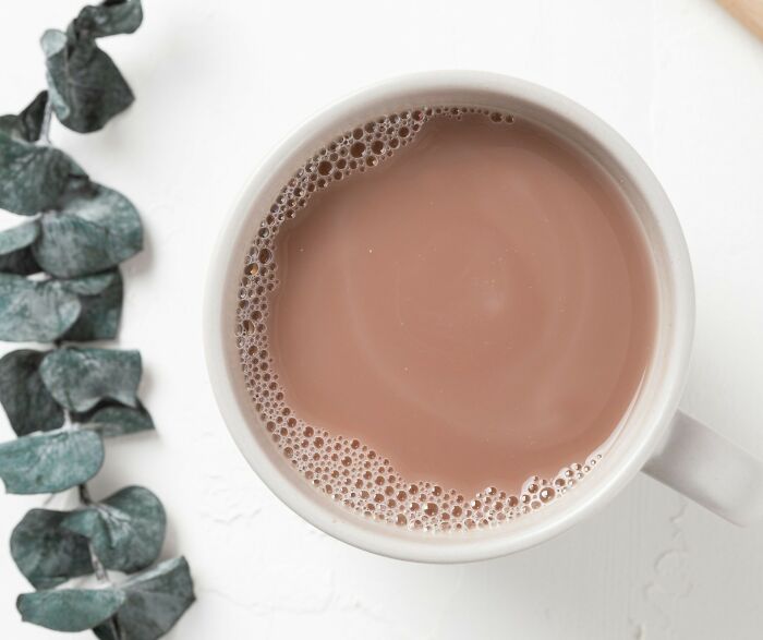 A mug of hot chocolate on a white surface, symbolizing a lifetime supply treat for winners.