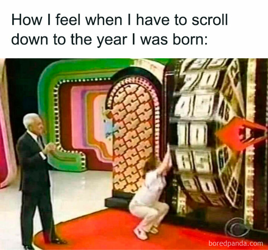 Person turning large game show wheel, humorously representing scrolling to birth year.