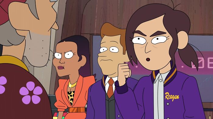 Animated characters intensely discussing wild theories, with one character wearing a jacket labeled "Reagan".