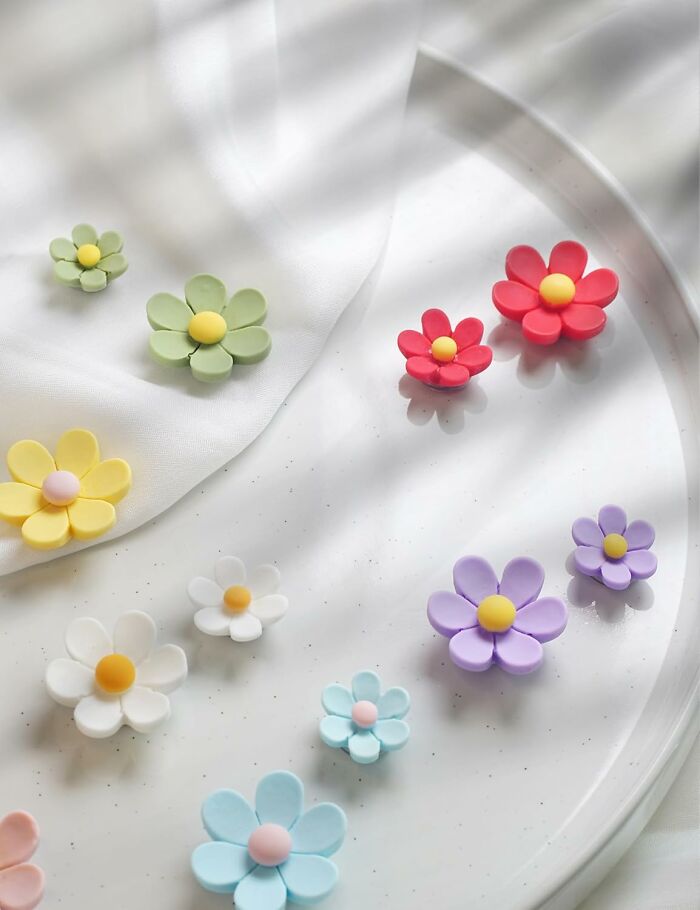 Colorful pastel flower decorations on a white surface, perfect spring finds for brightening up any space.