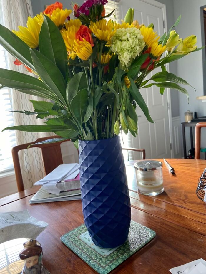 Colorful flower bouquet in a blue vase on a table, representing small businesses on Amazon.