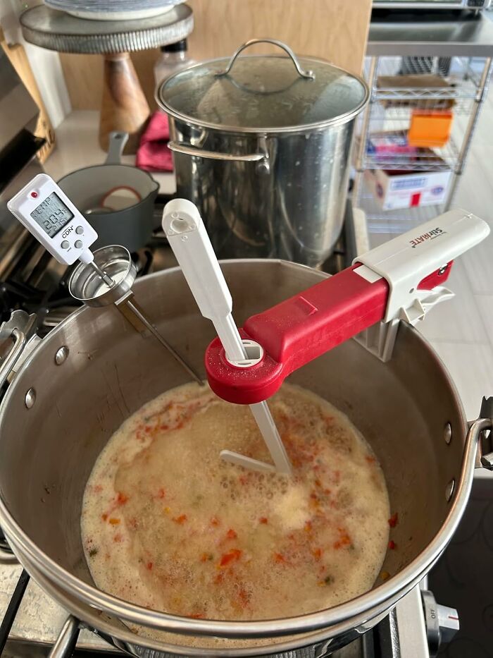 A pot of soup with a digital thermometer, showcasing adult life finds.