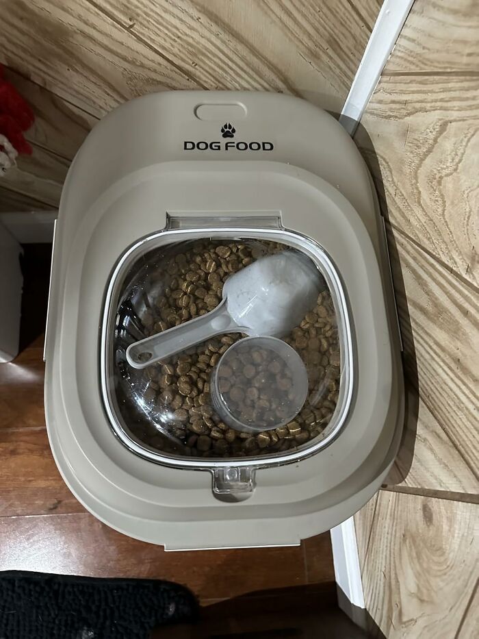Dog food container filled with kibble and a scoop, essentials for managing a Costco a*******n.
