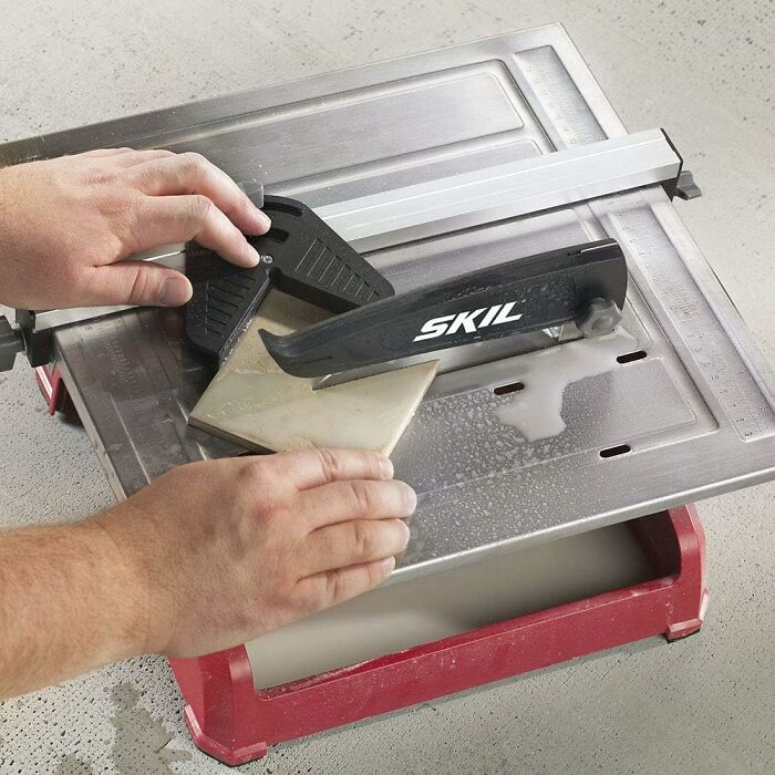 Hands using a Skil tile cutter, showcasing a contractor's secret tool technique.