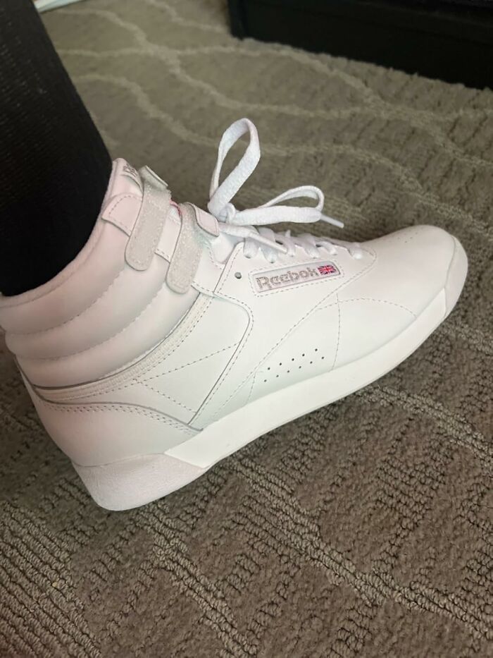 White Reebok high-top sneaker evokes 80s nostalgia.