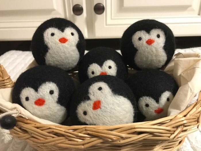 Basket of penguin-themed dryer balls, a cheapskate DIY alternative.