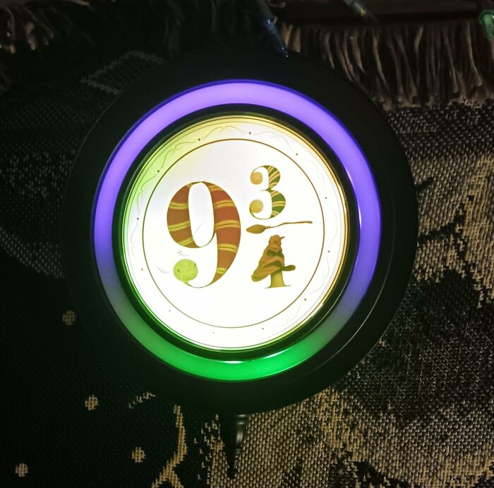 Movie prop with a 9 3/4 design, featuring a purple and green glow, inspired by a magical platform theme.