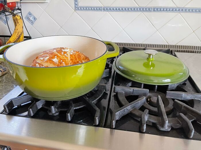 Green Dutch oven with fresh bread on a stovetop, representing spring finds.