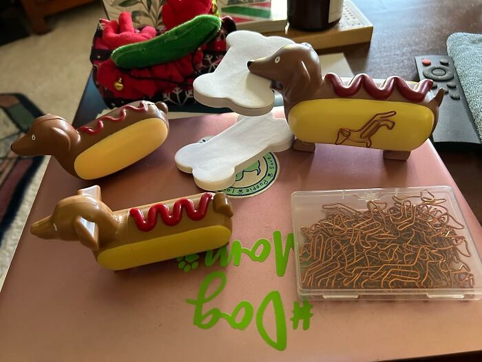 Dachshund-shaped hot dog dispensers and paper clips from Yobro shopping haul on a table.