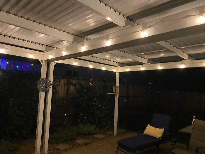 Cozy backyard patio with string lights at night, a spring must-have for outdoor relaxation.