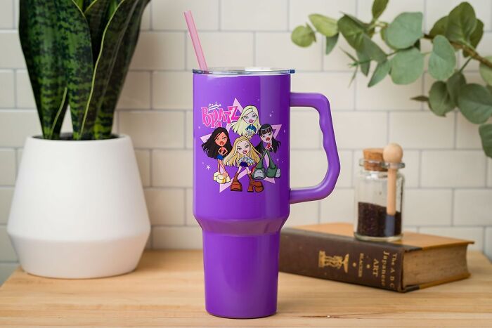 Purple Bratz tumbler with straw on a countertop, surrounded by a plant and a spice jar, showcasing fandom goals.