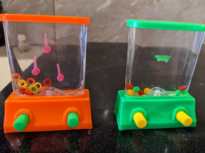 Retro water ring toss toys with orange and green bases from the 90s.