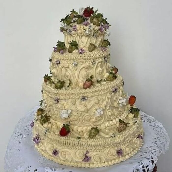 Decorative cake with intricate frosting and strawberries showcases a humorous baking fail in this funny cake shaming example.