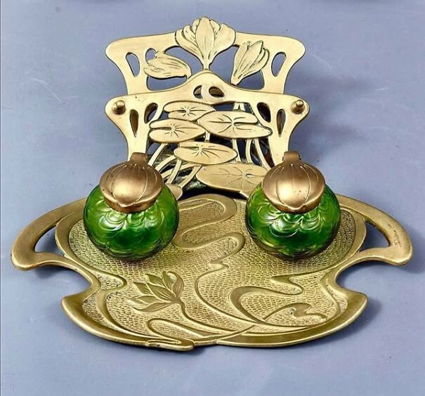 Strange thrifted item: intricate brass and green art nouveau decorative piece with floral motifs.