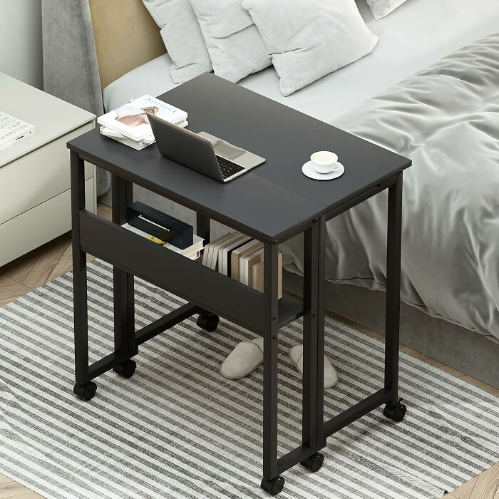 Compact mobile desk with laptop and books, ideal furniture solution for small spaces.