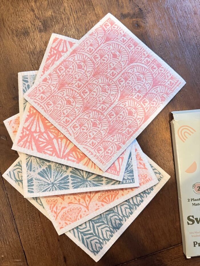 Colorful patterned spring finds on a wooden table, showcasing intricate pink and blue designs.