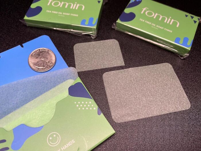 Tea tree oil soap sheets with packaging and a coin for size comparison, highly praised in reviews.