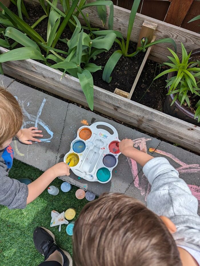 Children painting with colorful chalks, perfect for unique Easter basket stuffers.