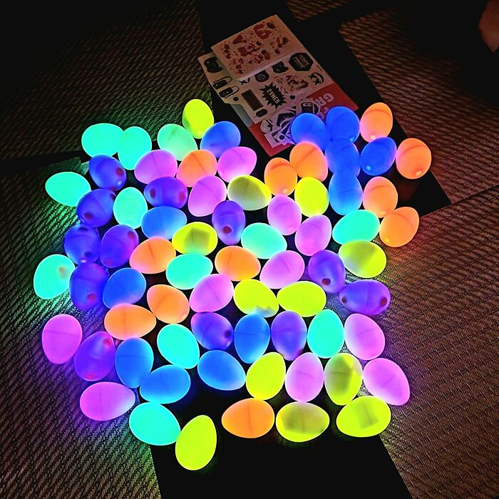 Glowing Easter eggs in vibrant colors spread on a surface, offering fun and creative holiday ideas.