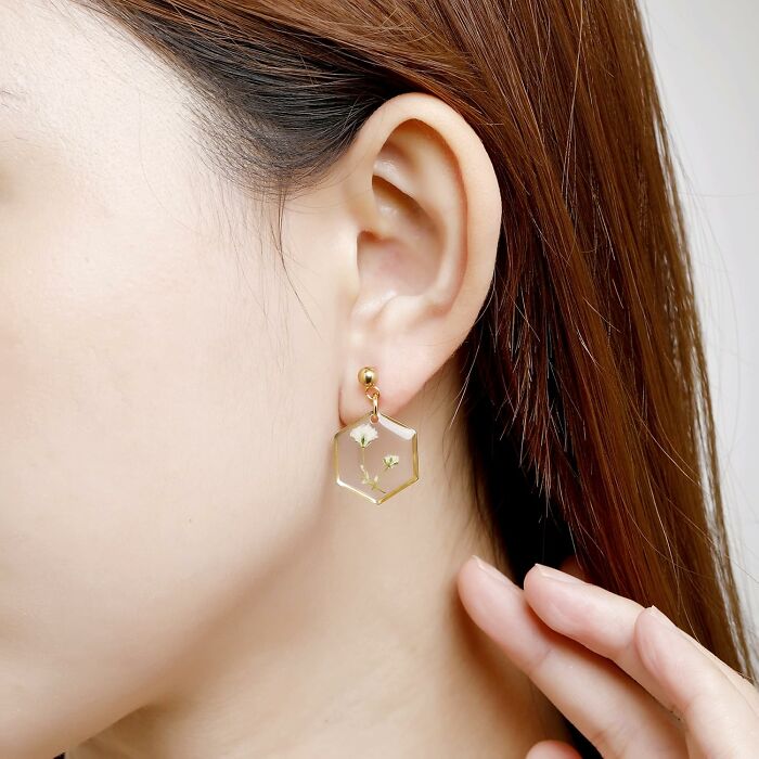 Hexagon earrings with delicate flowers, perfect for spring fashion essentials.