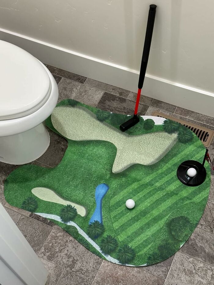 Golf-themed bathroom mat with putter and golf ball, showcasing toilet humour.