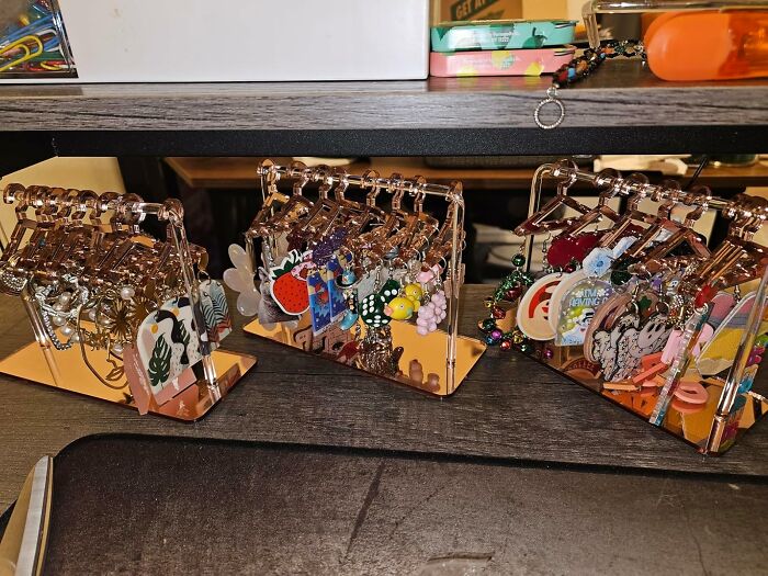 Colorful collection of random Amazon finds on small earring stands, showcasing quirky and unique designs.