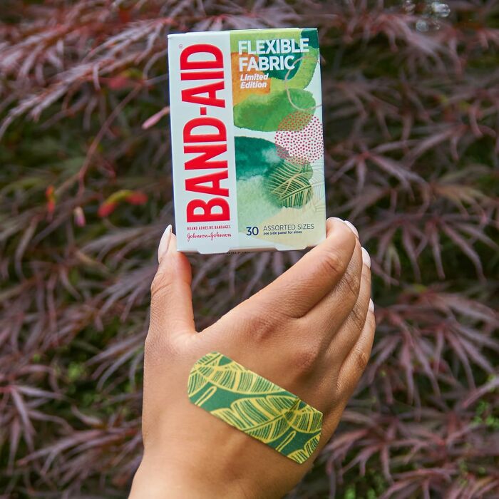 Hand holding limited edition Band-Aid box with green patterned bandage, showcasing spring finds.