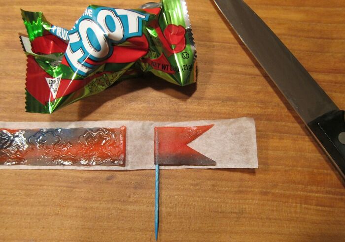 Fruit roll-up sliced on a table next to a knife, resembling a flag; easy money idea from an eating competition.