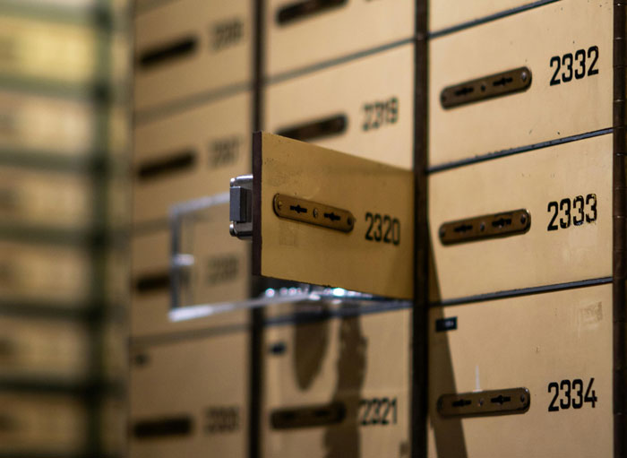 Open safe deposit box in a bank vault, highlighting favorite places to hide things at home.