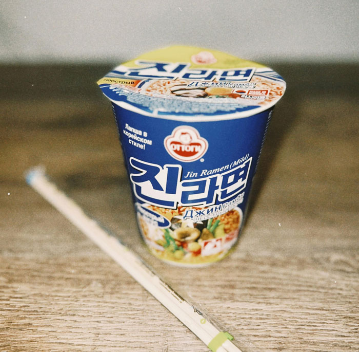 Instant Jin Ramen cup with chopsticks, representing lazy meals.