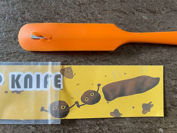 Orange plastic utensil with humorous cartoon p**p illustration, related to toilet humour.